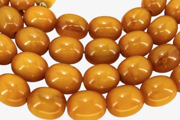 Close-up of butterscotch Bakelite beads showing marbling and glow